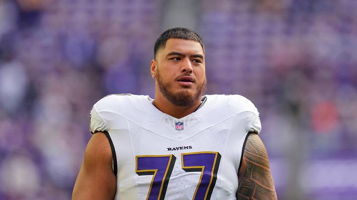 Nov 9, 2025; Minneapolis, Minnesota, USA; Baltimore Ravens guard Daniel Faalele (77) warms up before the game against the Minnesota Vikings at U.S. Bank Stadium.  