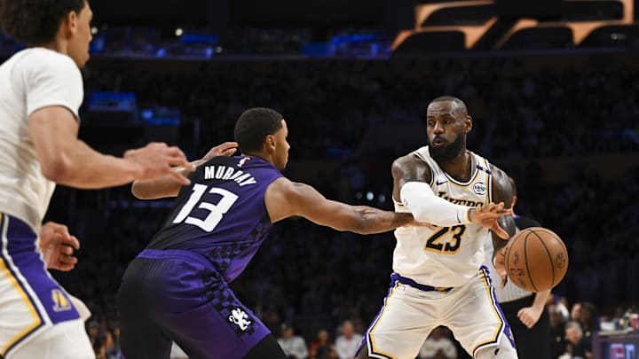Oct 26, 2024; Los Angeles, California, USA; Los Angeles Lakers forward LeBron James (23) passes against Sacramento Kings forward Keegan Murray (13) during the second half at Crypto.com Arena. Mandatory Credit: Jonathan Hui-Imagn Images