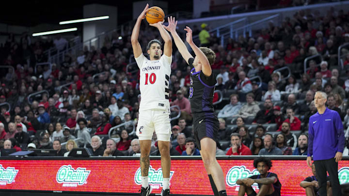 Nov 3, 2025; Cincinnati, Ohio, USA; Cincinnati Bearcats guard Shon Abaev (10) attempts a 3-point shot against Western Carolina Catamounts forward Marcus Kell (23) in the first half at Fifth Third Arena. Mandatory Credit: Aaron Doster-Imagn Images Nov 3, 2025; Cincinnati, Ohio, USA; Cincinnati Bearcats guard Shon Abaev (10) attempts a 3-point shot against Western Carolina Catamounts forward Marcus Kell (23) in the first half at Fifth Third Arena. Mandatory Credit: Aaron Doster-Imagn Images