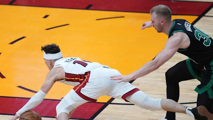 Apr 27, 2024; Miami, Florida, USA; Miami Heat guard Tyler Herro (14) goes down after colliding with the Celtics' Sam Hauser