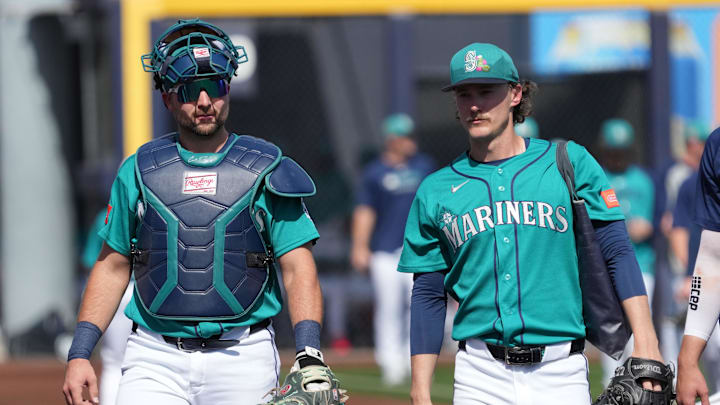 Feb 26, 2026; Peoria, Arizona, USA; Seattle Mariners catcher Cal Raleigh (29) and pitcher Bryce Miller (50) walk to the dugout before the game against the Cleveland Guardians at Peoria Sports Complex. Mandatory Credit: Rick Scuteri-Imagn Images