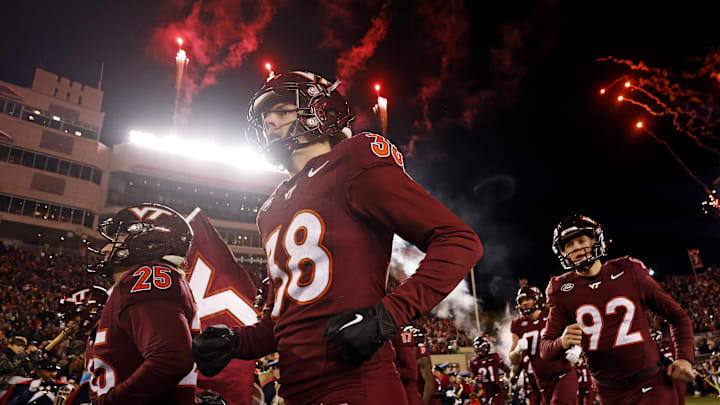 Nov 30, 2024; Blacksburg, Virginia, USA; The Virginia Tech Hokies runs onto the field during “Enter Sandman” before playing against the Virginia Cavaliers at Lane Stadium. Mandatory Credit: Peter Casey-Imagn Images