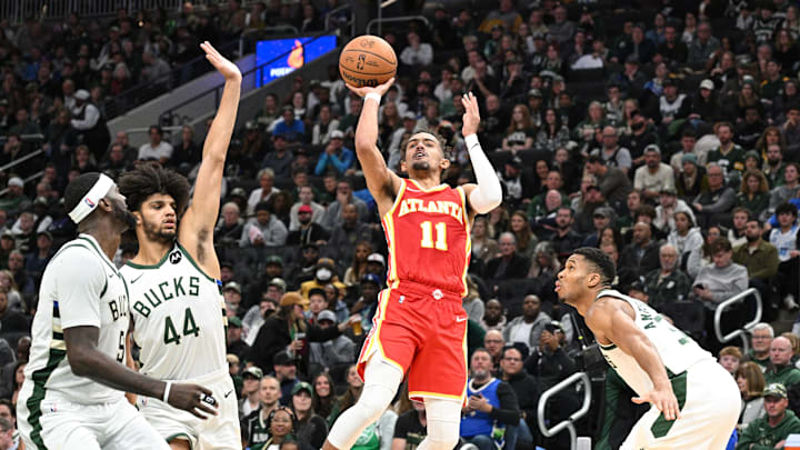 Oct 29, 2023; Milwaukee, Wisconsin, USA; Atlanta Hawks guard Trae Young (11) puts up a shot between Milwaukee Bucks guard Andre Jackson Jr. (44) and Milwaukee Bucks forward Giannis Antetokounmpo (34) in the second half at Fiserv Forum. Mandatory Credit: Michael McLoone-Imagn Images