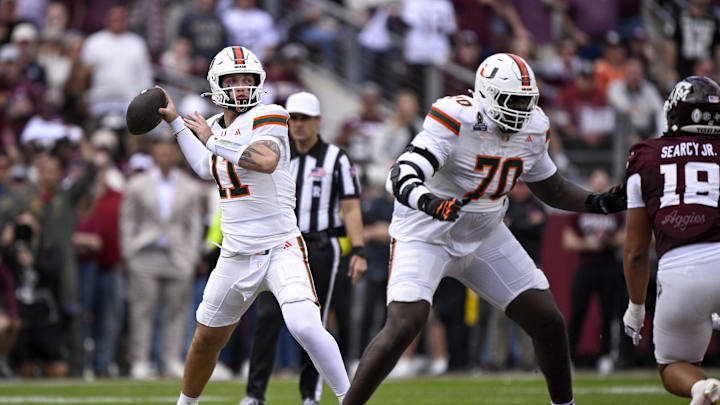 Dec 20, 2025; College Station, TX, USA; Miami Hurricanes quarterback Carson Beck (11) looks to throw the ball behind offensive lineman Markel Bell (70) during the game between the Aggies and the Hurricanes at Kyle Field. Mandatory Credit: Jerome Miron-Imagn Images Dec 20, 2025; College Station, TX, USA; Miami Hurricanes quarterback Carson Beck (11) looks to throw the ball behind offensive lineman Markel Bell (70) during the game between the Aggies and the Hurricanes at Kyle Field. Mandatory Credit: Jerome Miron-Imagn Images
