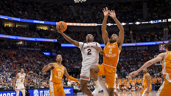 Mar 15, 2025; Nashville, TN, USA;  Auburn Tigers guard Denver Jones (2) goes up for a shot as Tennessee Volunteers guard Chaz Lanier (2) defends during the second half at Bridgestone Arena. Mandatory Credit: Steve Roberts-Imagn Images