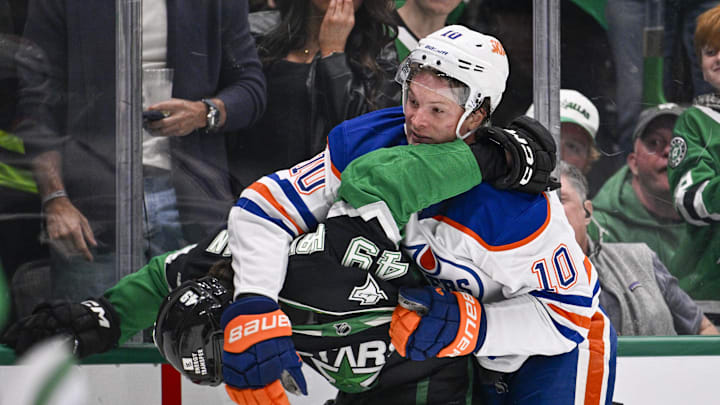 Mar 12, 2026; Dallas, Texas, USA; Dallas Stars center Justin Hryckowian (49) fights with Edmonton Oilers center Trent Frederic (10) during the third period at the American Airlines Center. Mandatory Credit: Jerome Miron-Imagn Images