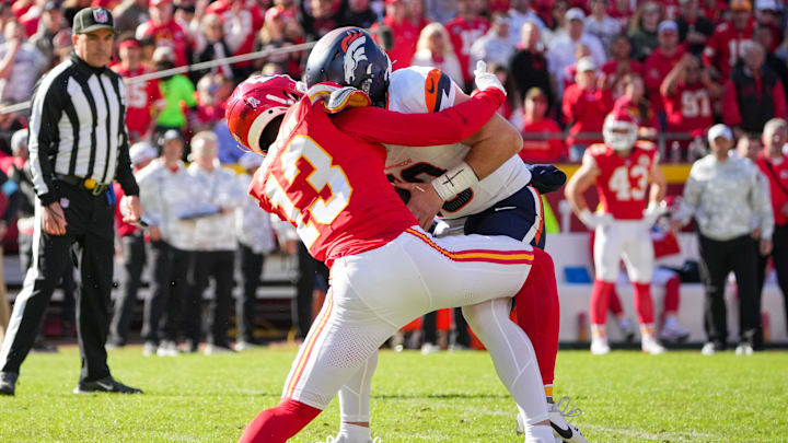 Nov 10, 2024; Kansas City, Missouri, USA; Denver Broncos quarterback Bo Nix (10) is sacked by Kansas City Chiefs safety Nazeeh Johnson (13) during the first half at GEHA Field at Arrowhead Stadium. Mandatory Credit: Denny Medley-Imagn Images