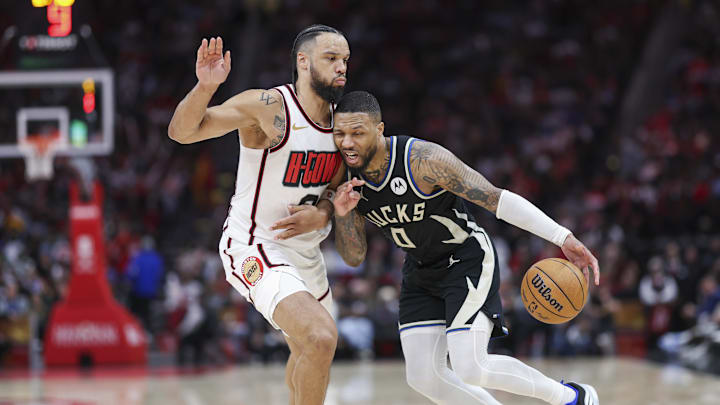 Feb 25, 2025; Houston, Texas, USA; Milwaukee Bucks guard Damian Lillard (0) dribbles the ball as Houston Rockets forward Dillon Brooks (9) defends during the fourth quarter at Toyota Center. Mandatory Credit: Troy Taormina-Imagn Images