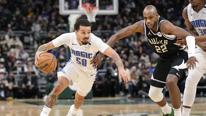 Jan 15, 2025; Milwaukee, Wisconsin, USA;  Orlando Magic guard Cole Anthony (50) drives towards the basket around Milwaukee Bucks forward Khris Middleton (22) during the third quarter at Fiserv Forum. Mandatory Credit: Jeff Hanisch-Imagn Images