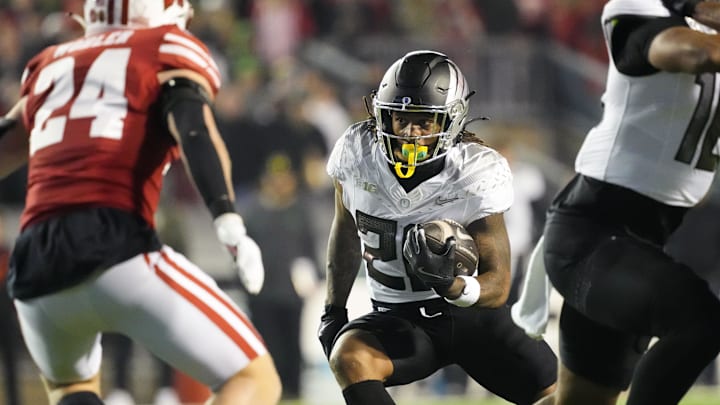 Nov 16, 2024; Madison, Wisconsin, USA;  Oregon Ducks running back Jordan James (20) rushes with the football during the fourth quarter against the Wisconsin Badgers at Camp Randall Stadium. 