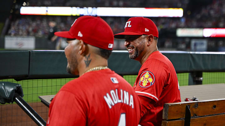 Aug 8, 2025; St. Louis, Missouri, USA;  St. Louis Cardinals manager Oliver Marmol (37) and guest coach Yadier Molina (4) react after right fielder Jordan Walker (not pictured) hit a solo home run against the Chicago Cubs during the sixth inning at Busch Stadium. Mandatory Credit: Jeff Curry-Imagn Images