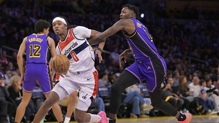 Jan 21, 2025; Los Angeles, California, USA;   Washington Wizards guard Bilal Coulibaly (0) drives past Los Angeles Lakers forward Dorian Finney-Smith (17) in the first half at Crypto.com Arena. Mandatory Credit: Jayne Kamin-Oncea-Imagn Images
