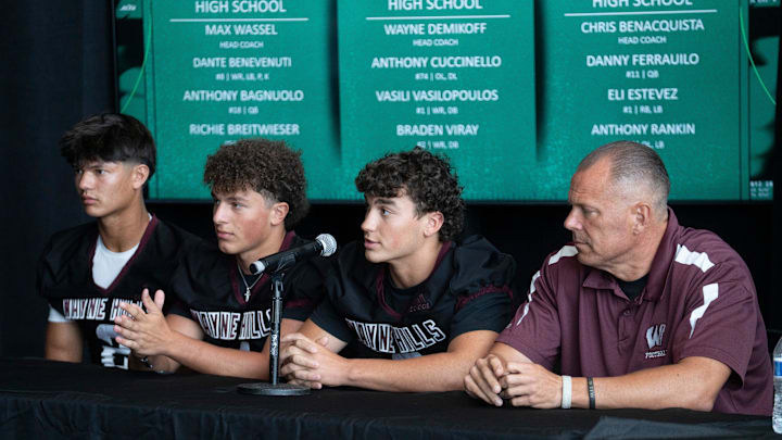 From left, Wayne Hills’ Braden Viray, Vasili Vasilopoulos, Anthony Cuccinello, and head coach Wayne Demikoff sit down for a panel during Super Football Conference Media Day at MetLife Stadium on Tuesday, Aug. 19, 2025.