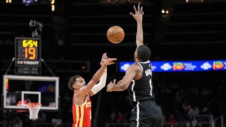Dec 6, 2023; Atlanta, Georgia, USA; Atlanta Hawks guard Trae Young (11) shoots against Brooklyn Nets forward Mikal Bridges (1) during the first half at State Farm Arena. Mandatory Credit: Dale Zanine-USA TODAY Sports