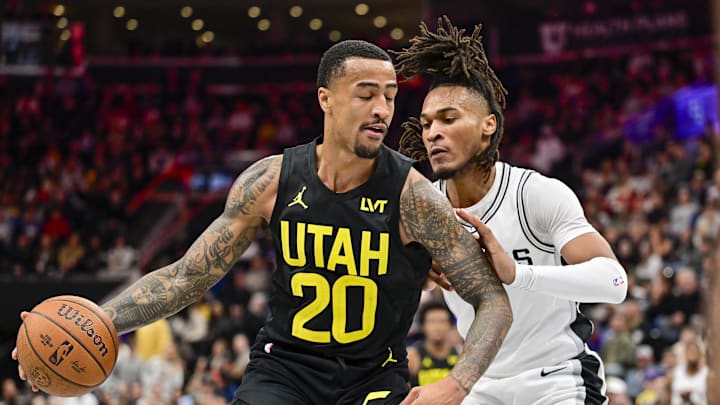 Nov 26, 2024; Salt Lake City, Utah, USA; Utah Jazz forward/center John Collins (20) dribbles around San Antonio Spurs guard Stephon Castle (5) during the first half at the Delta Center. Mandatory Credit: Christopher Creveling-Imagn Images