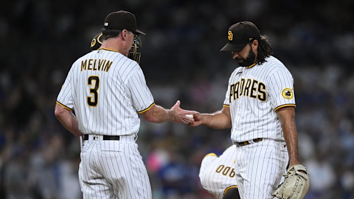 San Diego Padres manager Bob Melvin (3) takes the ball from relief pitcher Nabil Crismatt (74) during a pitching change in the seventh inning against the Los Angeles Dodgers at Petco Park on Sept. 10, 2022. San Diego Padres manager Bob Melvin (3) takes the ball from relief pitcher Nabil Crismatt (74) during a pitching change in the seventh inning against the Los Angeles Dodgers at Petco Park on Sept. 10, 2022.