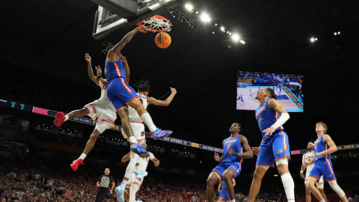 Apr 5, 2025; San Antonio, TX, USA; Florida Gators guard Alijah Martin (15) dunks the ball against Auburn Tigers guard Tahaad Pettiford (0) and guard Chad Baker-Mazara (10) during the second half in the semifinals of the men's Final Four of the 2025 NCAA Tournament at the Alamodome. Mandatory Credit: Bob Donnan-Imagn Images