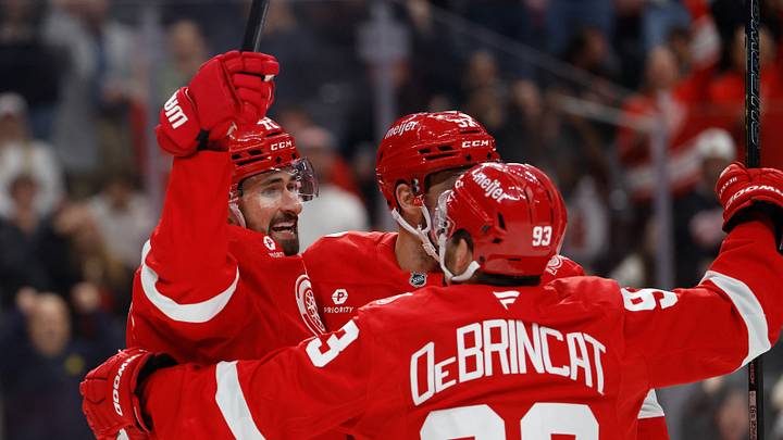 Detroit Red Wings center Dylan Larkin (71) receives congratulations from teammates after scoring in the second period against the Philadelphia Flyers at Little Caesars Arena. Mandatory Credit: Rick Osentoski-Imagn Images