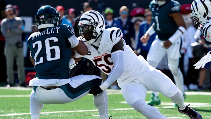 Cincinnati Bengals linebacker Akeem Davis-Gaither (59) tackles Philadelphia Eagles running back Saquon Barkley (26) in the second quarter of the NFL game at Paycor Stadium in Cincinnati on Sunday, Oct. 27, 2024. Cincinnati Bengals linebacker Akeem Davis-Gaither (59) tackles Philadelphia Eagles running back Saquon Barkley (26) in the second quarter of the NFL game at Paycor Stadium in Cincinnati on Sunday, Oct. 27, 2024.