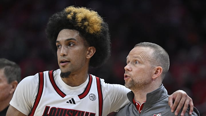 Dec 11, 2024; Louisville, Kentucky, USA;  Louisville Cardinals head coach Pat Kelsey talks with guard Chucky Hepburn (24) during the second half against the UTEP Miners at KFC Yum! Center. Louisville defeated Texas-El Paso 77-74. Mandatory Credit: Jamie Rhodes-Imagn Images