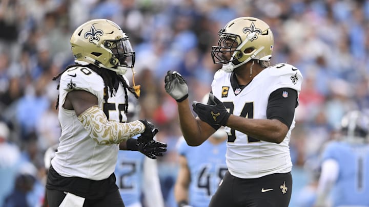 Dec 28, 2025; Nashville, Tennessee, USA;  New Orleans Saints linebacker Demario Davis (56) and defensive end Cameron Jordan (94) celebrate a sack against the Tennessee Titans during the second half of the game at Nissan Stadium. Mandatory Credit: Steve Roberts-Imagn Images
