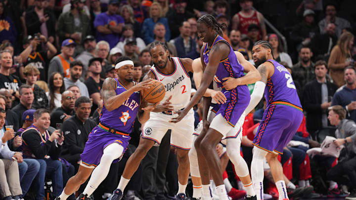 Mar 4, 2025; Phoenix, Arizona, USA; Phoenix Suns guard Bradley Beal (3) takes a pass from Phoenix Suns center Bol Bol (11) against LA Clippers forward Kawhi Leonard (2) during the first half at PHX Center. Mandatory Credit: Joe Camporeale-Imagn Images