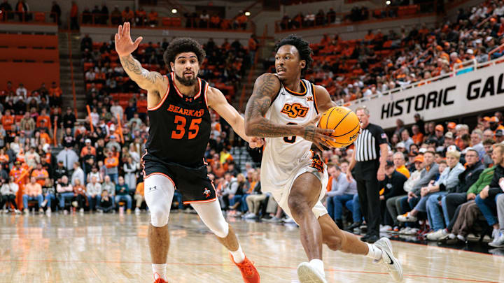 Dec 2, 2025; Stillwater, Oklahoma, USA; Oklahoma State Cowboys guard Anthony Roy (9) drives to the basket around Sam Houston Bearkats guard Po'Boigh King (35) during the first half at Gallagher-Iba Arena. Mandatory Credit: William Purnell-Imagn Images Dec 2, 2025; Stillwater, Oklahoma, USA; Oklahoma State Cowboys guard Anthony Roy (9) drives to the basket around Sam Houston Bearkats guard Po'Boigh King (35) during the first half at Gallagher-Iba Arena. Mandatory Credit: William Purnell-Imagn Images