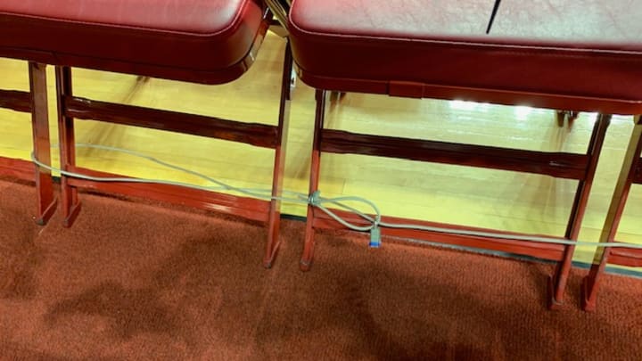 The chairs on the benches are now chained down so no coach — no matter how iconic — can throw one across the court.
