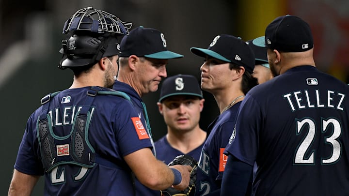 Seattle Mariners manager Dan Wilson (6) takes the ball from Mariners starting pitcher Bryan Woo (22) during the seventh inning against the Texas Rangers at Globe Life Field on May 2.