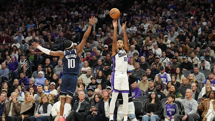 Dec 30, 2024; Sacramento, California, USA; Sacramento Kings forward Keegan Murray (13) shoots against Dallas Mavericks guard Brandon Williams (10) during the fourth quarter at Golden 1 Center. Mandatory Credit: Darren Yamashita-Imagn Images