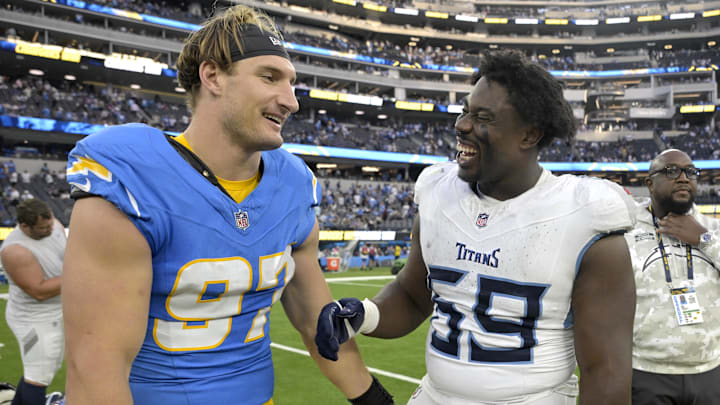 Nov 10, 2024; Inglewood, California, USA;  Los Angeles Chargers linebacker Joey Bosa (97) and Tennessee Titans defensive tackle Sebastian Joseph-Day (69) meet on the field following the game at SoFi Stadium. Mandatory Credit: Jayne Kamin-Oncea-Imagn Images