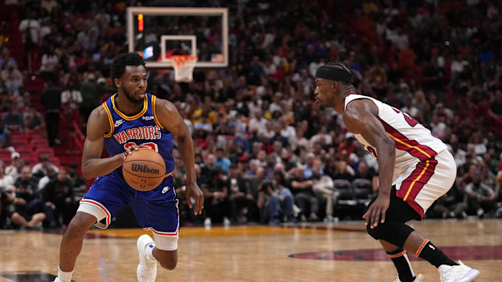 Mar 23, 2022; Miami, Florida, USA; Golden State Warriors forward Andrew Wiggins (22) drives the ball around Miami Heat forward Jimmy Butler (22) during the second half at FTX Arena. Mandatory Credit: Jasen Vinlove-Imagn Images Mar 23, 2022; Miami, Florida, USA; Golden State Warriors forward Andrew Wiggins (22) drives the ball around Miami Heat forward Jimmy Butler (22) during the second half at FTX Arena. Mandatory Credit: Jasen Vinlove-Imagn Images