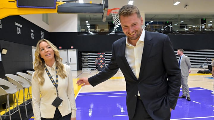 Aug 2, 2025; El Segundo, CA, USA; Los Angeles Lakers Luka Doncic (77) talks with team co-owner Jeanie Buss following a press conference announcing the signing of a 3-year, $165 million contract extension at UCLA Health Training Center. Mandatory Credit: Jayne Kamin-Oncea-Imagn Images