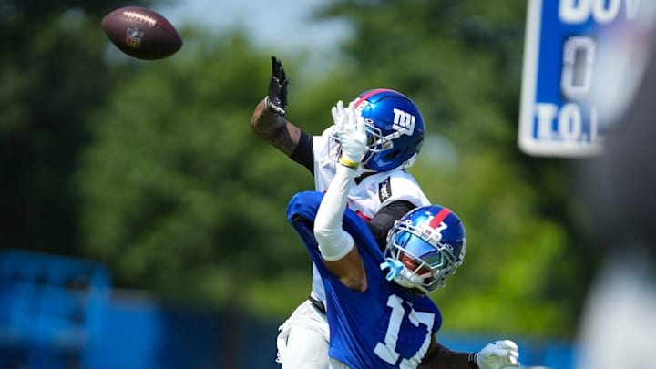 New York Giants cornerback Dru Phillips (22) attempts to block the ball from New York Giants wide receiver Wan'Dale Robinson (17) during a drill on day two of training camp at Quest Diagnostics Giants Training Center.