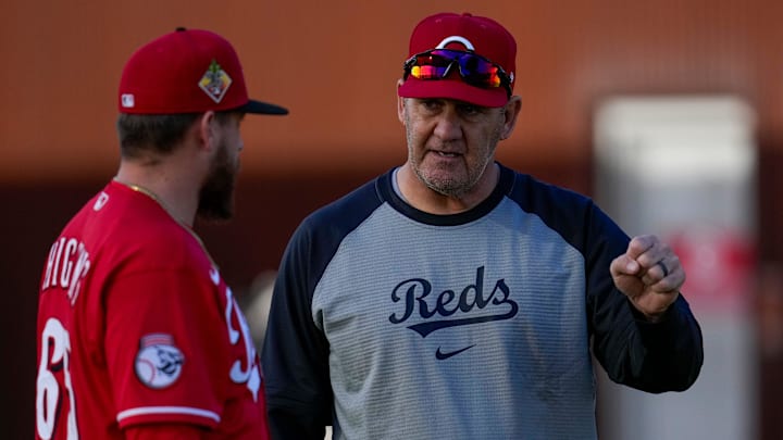 Cincinnati Reds catching coach Bill Haselman talks with catcher P.J. Higgins (65) before a workout at the Cincinnati Reds player development complex in Goodyear, Ariz., on Thursday, Feb. 12, 2026.