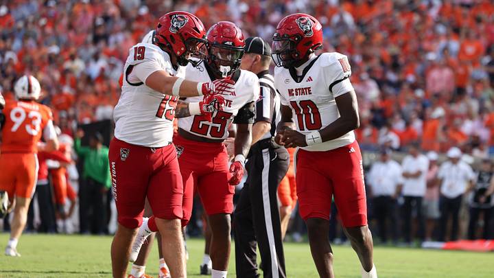 Aug 29, 2026; Charlottesville, Virginia, USA;  North Carolina State Wolfpack quarterback Will Wilson (10), tight end Preston Douglas (19), and running back Darius Johnson (25) celebrate a touchdown during the third quarter of the game against the Virginia Cavaliers at Scott Stadium.  Mandatory Credit: Greg Atkins-Imagn Images