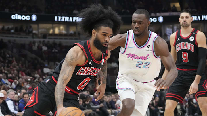Apr 9, 2025; Chicago, Illinois, USA; Miami Heat forward Andrew Wiggins (22) defends Chicago Bulls guard Coby White (0) during the first quarter at United Center. Mandatory Credit: David Banks-Imagn Images