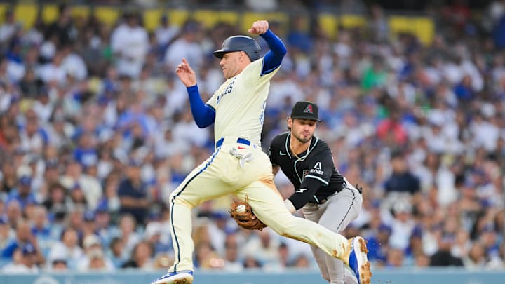 Aug 30, 2025; Los Angeles, California, USA; Arizona Diamondbacks shortstop Blaze Alexander (9) tags out Los Angeles Dodgers first baseman Freddie Freeman (5)  during the fourth inning against the Arizona Diamondbacks at Dodger Stadium. Mandatory Credit: Jayne Kamin-Oncea-Imagn Images