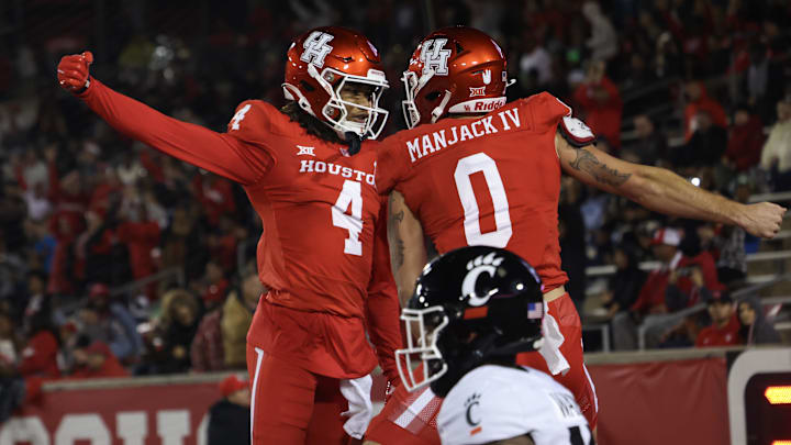 Houston Cougars wide receiver Samuel Brown (4) celebrates wide receiver Joseph Manjack IV (0) touchdown reception against Cincinnati Bearcats defensive back Taj Ward (15) in the first half at TDECU Stadium. Houston Cougars wide receiver Samuel Brown (4) celebrates wide receiver Joseph Manjack IV (0) touchdown reception against Cincinnati Bearcats defensive back Taj Ward (15) in the first half at TDECU Stadium.