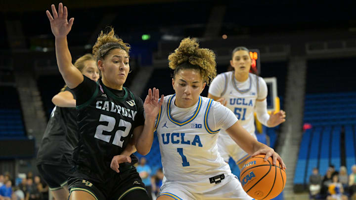 Dec 16, 2025; Los Angeles, California, USA;  Cal Poly Mustangs guard Alana Goosby (22) defends UCLA Bruins guard Kiki Rice (1) during the first half at Pauley Pavilion presented by Wescom Financial. Mandatory Credit: Jayne Kamin-Oncea-Imagn Images
