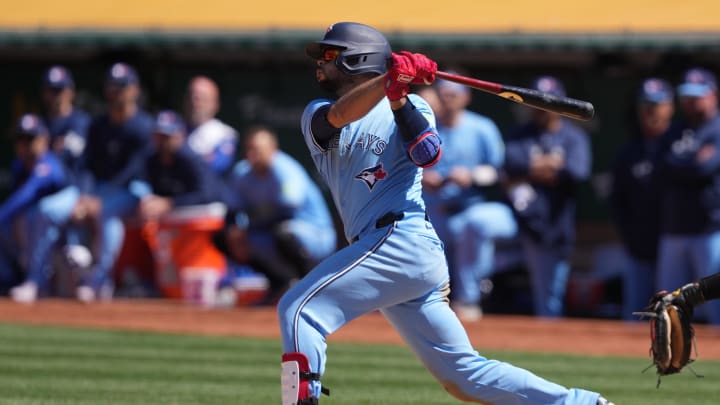Jun 9, 2024; Oakland, California, USA; Toronto Blue Jays third baseman Isiah Kiner-Falefa (7) hits an RBI double against the Oakland Athletics during the tenth inning at Oakland-Alameda County Coliseum. Mandatory Credit: Darren Yamashita-USA TODAY Sports