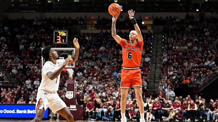 Feb 10, 2026; Tallahassee, Florida, USA; Virginia Cavaliers guard Jacari White (6) makes a three-point shot past Florida State Seminoles forward Chauncey Wiggins (7) during the second half at Donald L. Tucker Center. Mandatory Credit: Melina Myers-Imagn Images