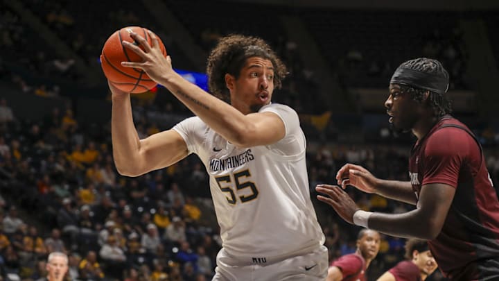 Dec 9, 2025; Morgantown, West Virginia, USA; West Virginia Mountaineers center Harlan Obioha (55) grabs a rebound during the first half against the Little Rock Trojans at Hope Coliseum. Mandatory Credit: Ben Queen-Imagn Images Dec 9, 2025; Morgantown, West Virginia, USA; West Virginia Mountaineers center Harlan Obioha (55) grabs a rebound during the first half against the Little Rock Trojans at Hope Coliseum. Mandatory Credit: Ben Queen-Imagn Images