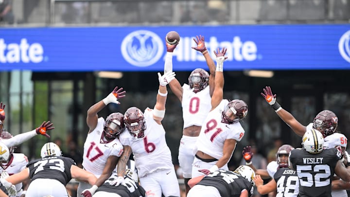 Aug 31, 2024; Nashville, Tennessee, USA;  Virginia Tech Hokies linebacker Keli Lawson (0) just misses the field goal of Vanderbilt Commodores place kicker Brock Taylor (88) during the second half at FirstBank Stadium. Mandatory Credit: Steve Roberts-Imagn Images