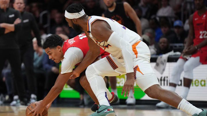 Dec 7, 2024; Miami, Florida, USA;  Miami Heat guard Dru Smith (12) grabs the ball against Phoenix Suns forward Josh Okogie (2) during the second half at Kaseya Center. Mandatory Credit: Jim Rassol-Imagn Images