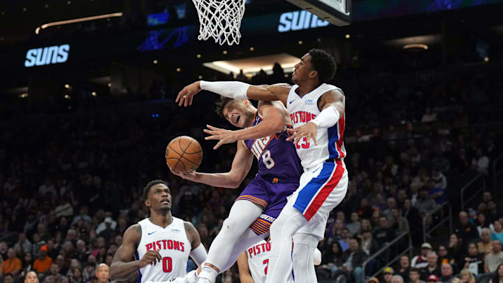 Feb 14, 2024; Phoenix, Arizona, USA; Phoenix Suns guard Grayson Allen (8) goes up for a layup against Detroit Pistons guard Jaden Ivey (23) during the first half at Footprint Center. Mandatory Credit: Joe Camporeale-Imagn Images