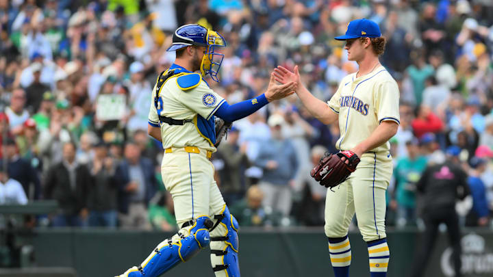 Seattle Mariners catcher Mitch Garver (18) and relief pitcher Troy Taylor (59) celebrate after defeating the Oakland Athletics at T-Mobile Park in 2024.