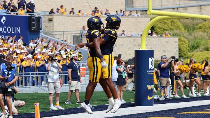 West Virginia University receiver DJ Epps celebrates with quarterback Michael Hawkins Jr. after a 53-yard touchdown receptions