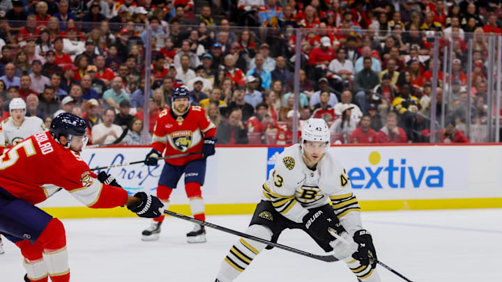 May 14, 2024; Sunrise, Florida, USA; Boston Bruins center Danton Heinen (43) moves the puck as Florida Panthers defenseman Aaron Ekblad (5) defends during the first period in game five of the second round of the 2024 Stanley Cup Playoffs at Amerant Bank Arena. Mandatory Credit: Sam Navarro-USA TODAY Sports