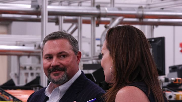 Texas Tech University System Board of Regents Chairman Cody Campbell listens to U.S. Department of Agriculture Secretary Brooke Rollins speak to other Texas Tech leaders at the USDA Agricultural Marketing Service Cotton Classification Complex on April 16, 2025